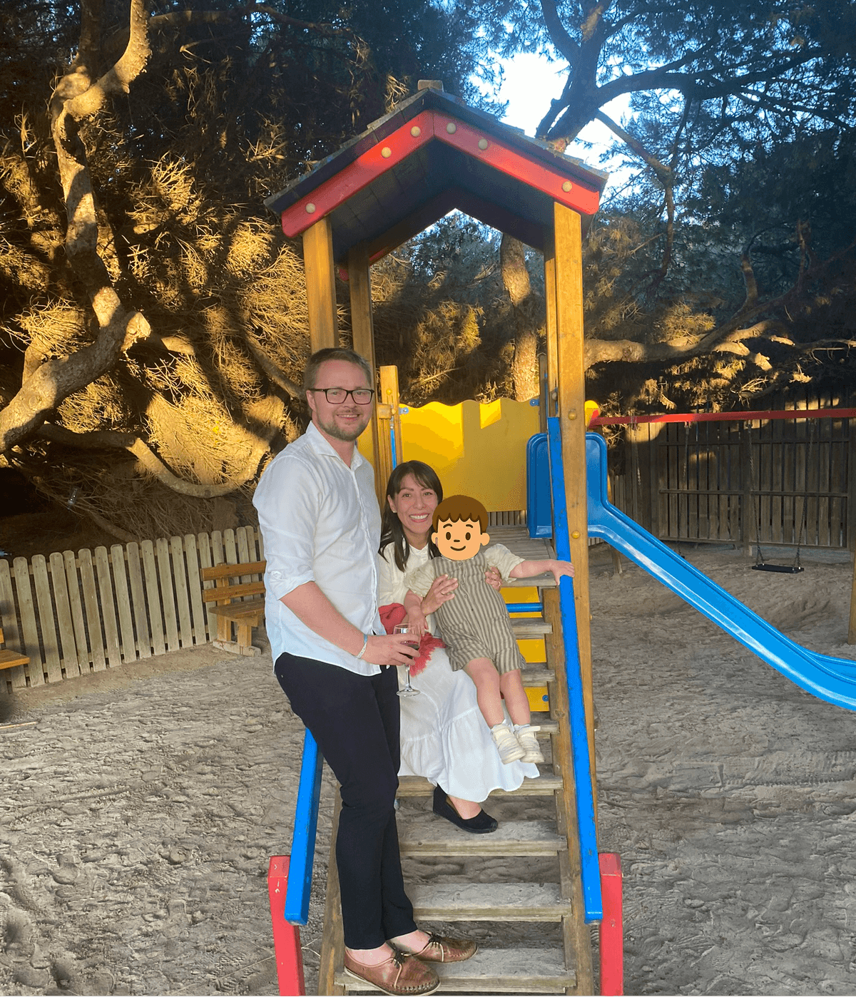 Nichlas, Eva, and their child at a playground, the real Toddler Vacation family.
